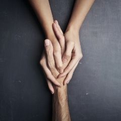 Holding hands on grey background