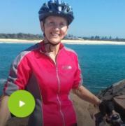 Woman holding a bike with bike helmet